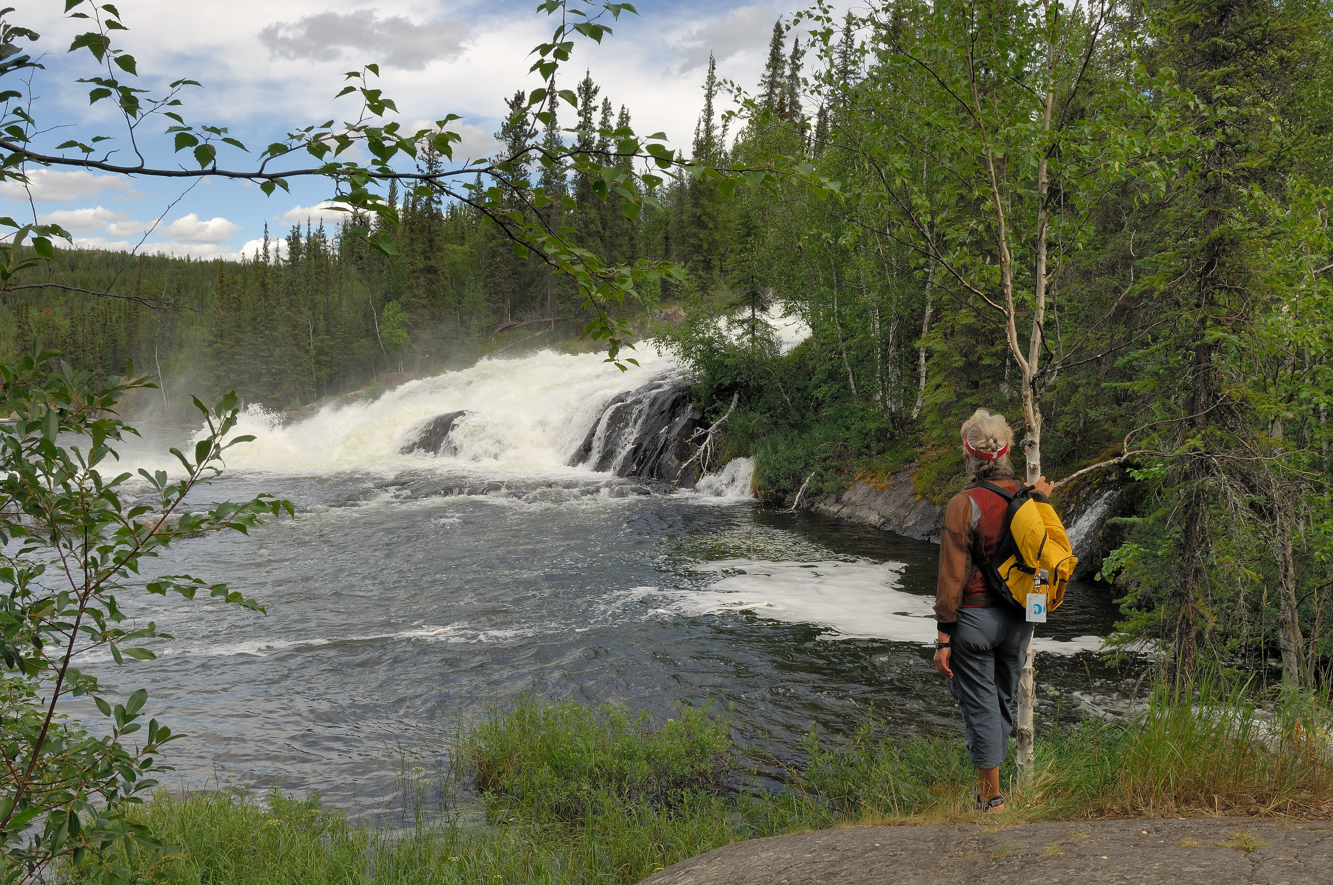 Women standing looking at small falls in Northwest Territories
