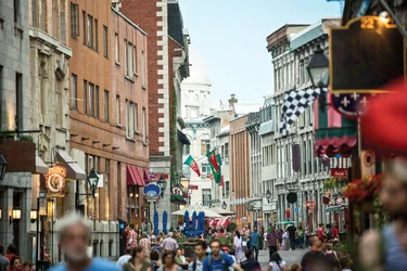A busy street in Montreal, crowded with shoppers and retail signange.