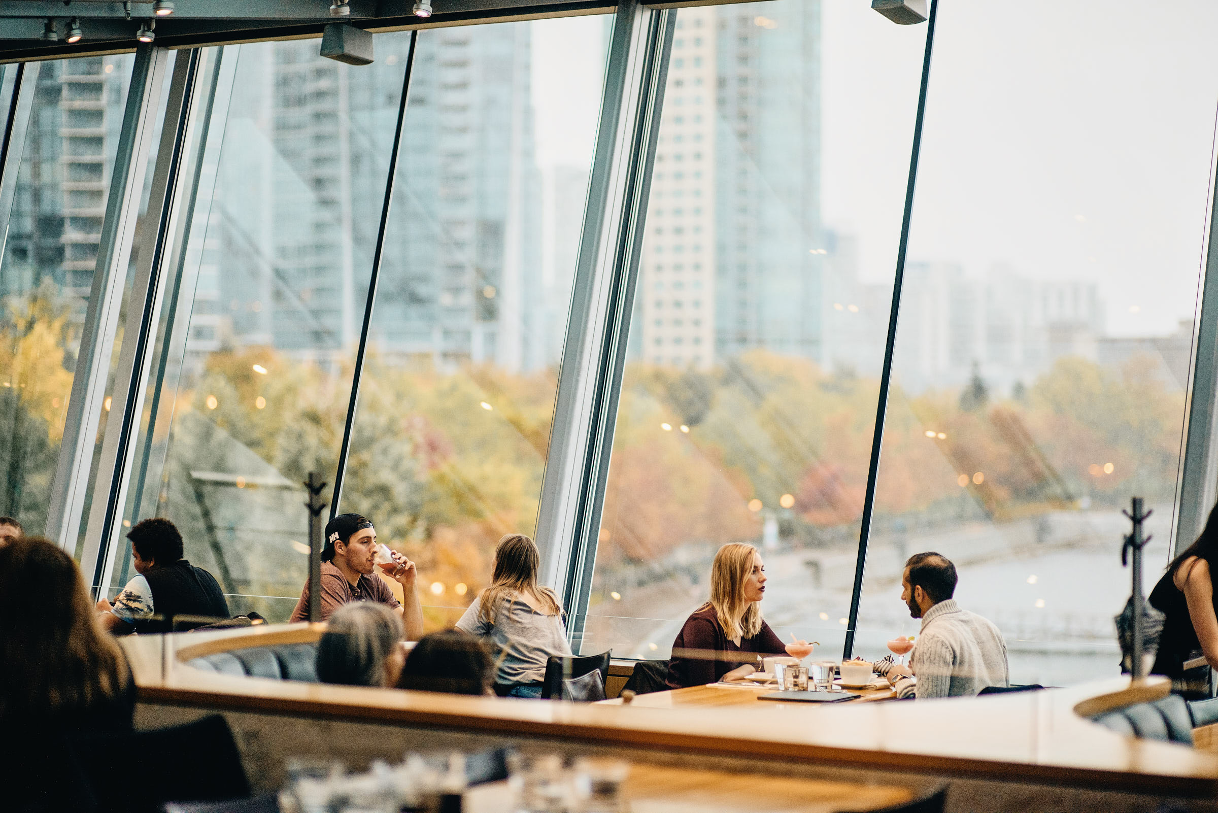 Diners beside a large picture window at a Vancouver restaurant