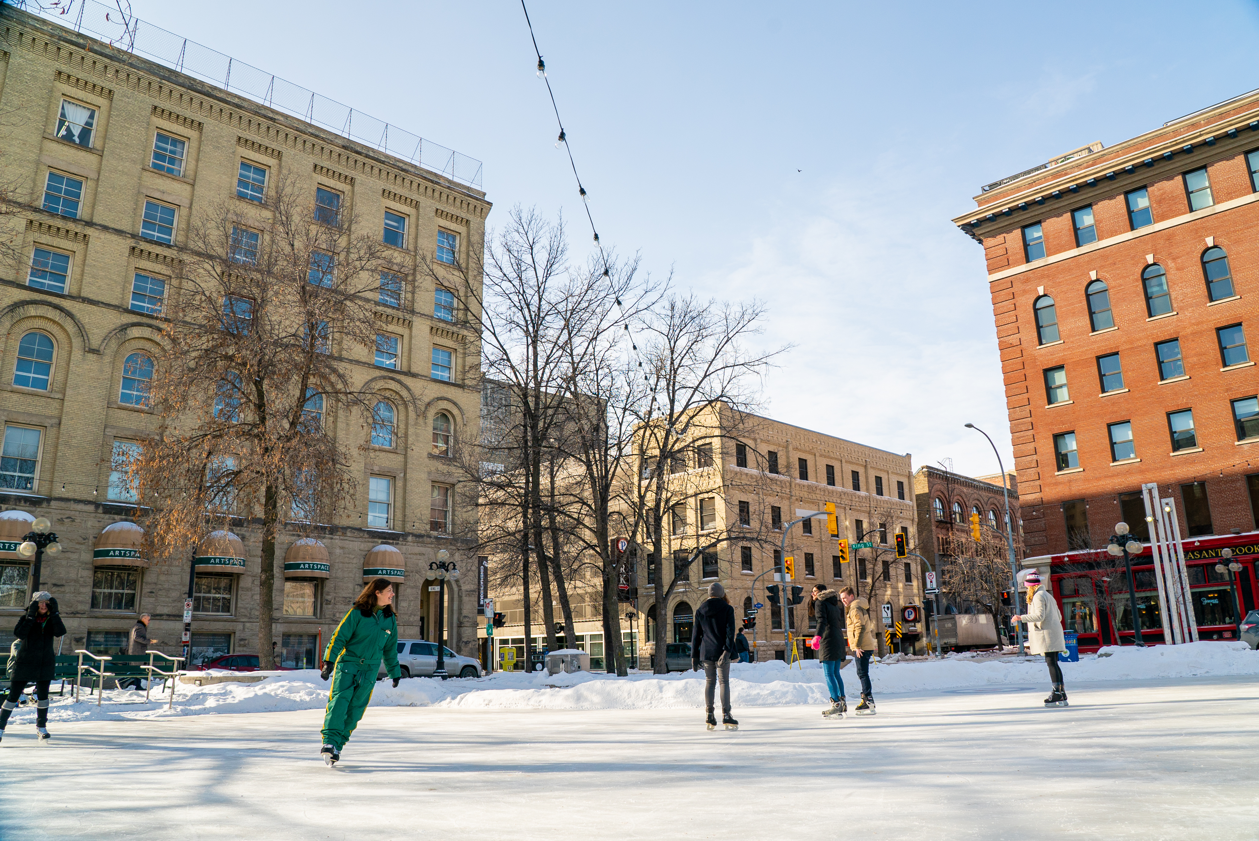 People ice skating in Old Market Square, against a backdrop of heritage buildings