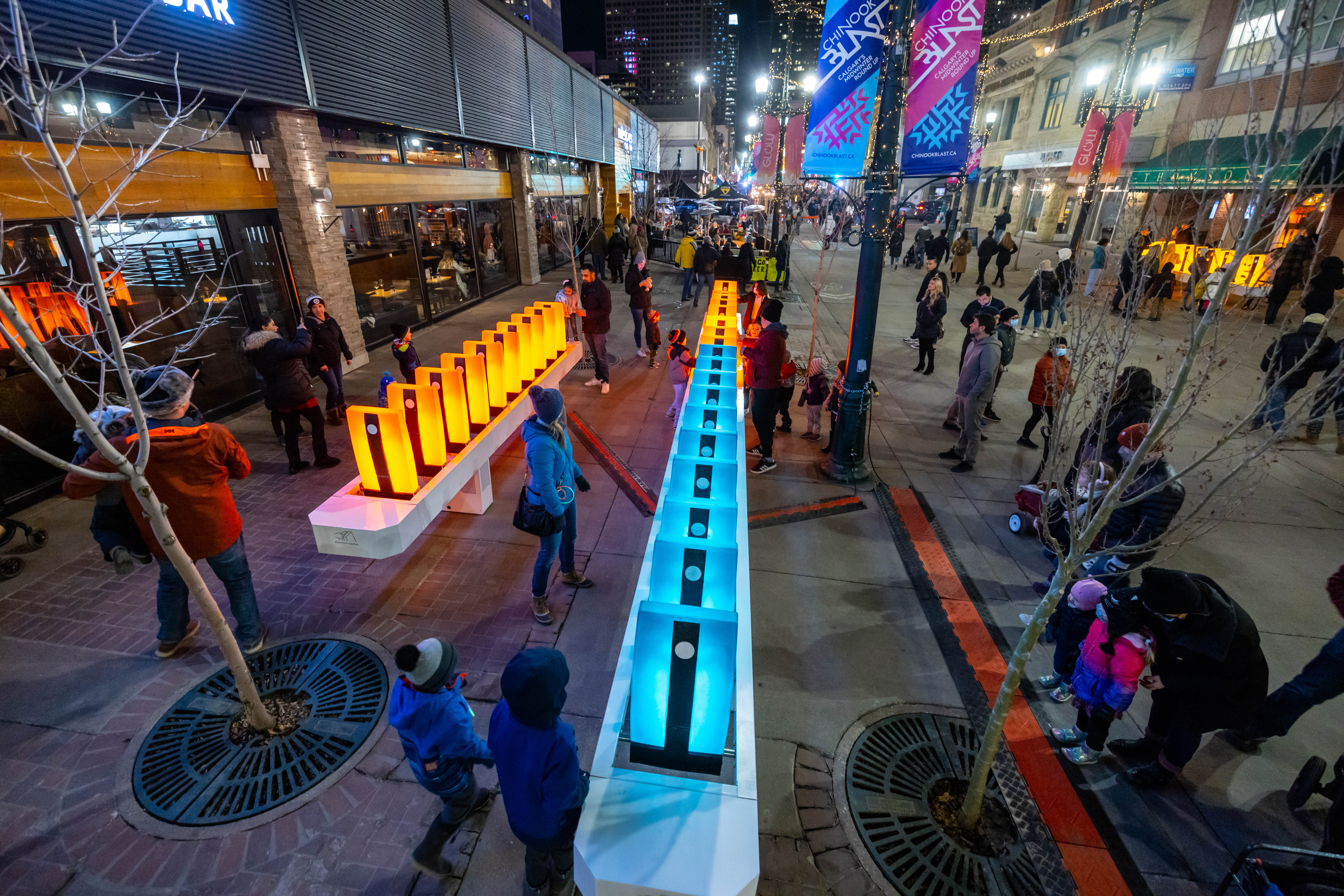 Festivalgoers gather around domino light and sound installation in downtown Calgary
