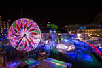 Entertainment festival area and large light wheel at night in Montreal
