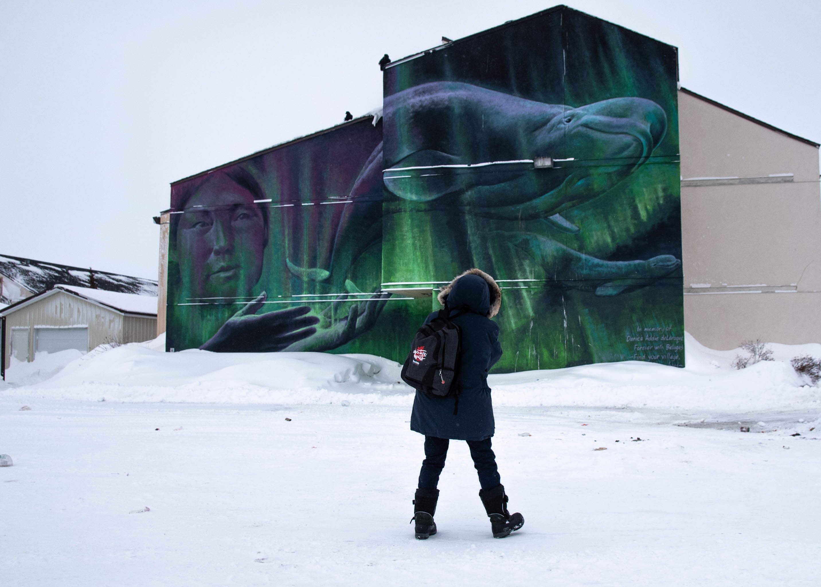 a person standing in front of a mural in Churchill Manitoba