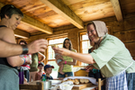 Woman dressed in periodic costume handing visitor bread