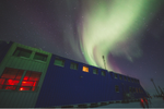 Exterior of the Churchill Northern Studies Centre with Northern Lights above