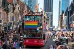 One of Toronto's City Sightseeing tour buses participates in the Pride Parade on Yonge Street