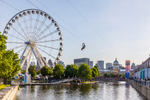 Montreal's large ferris wheel and a person zipling over the water