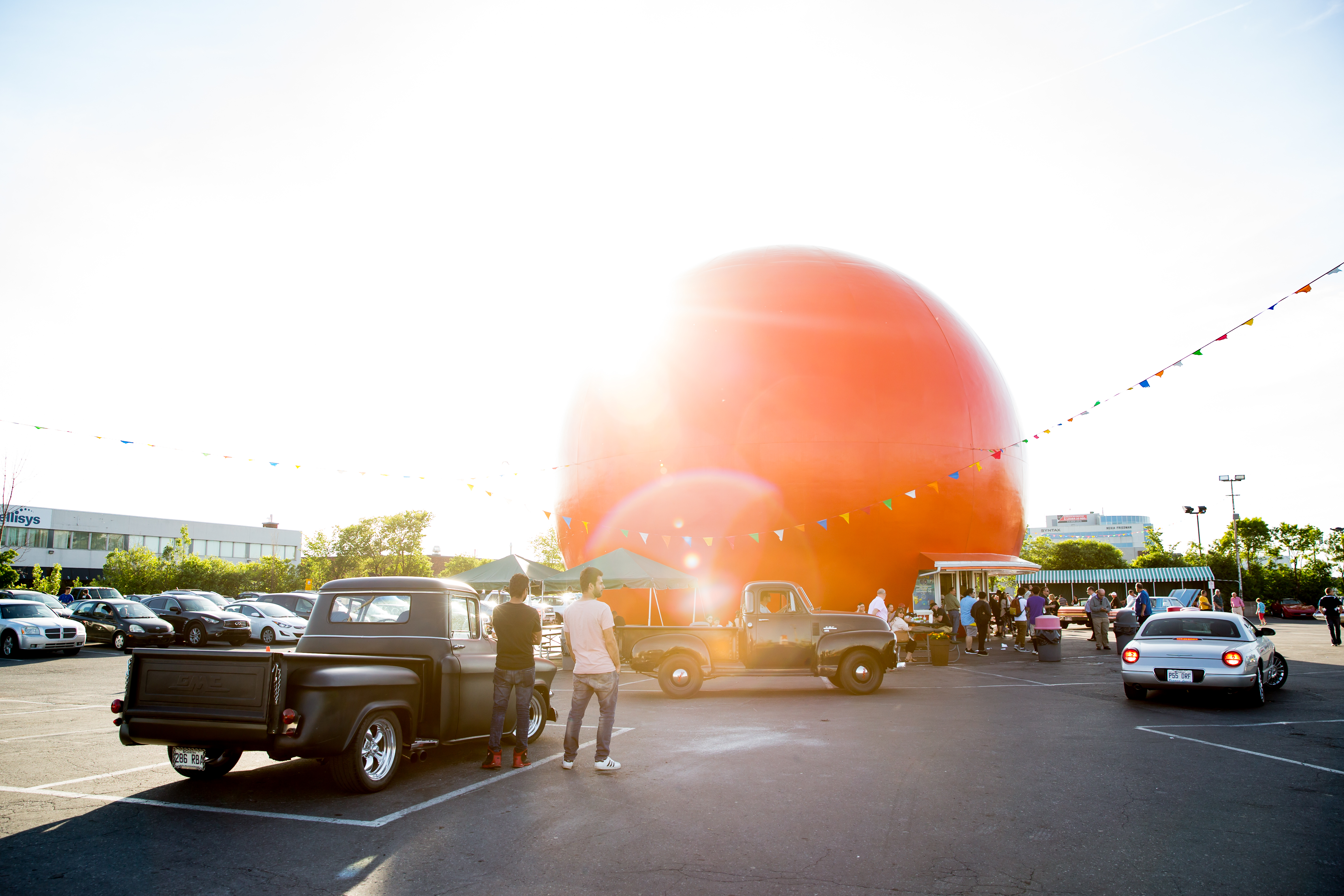 A giant orange orb next to a parking lot in Montreal