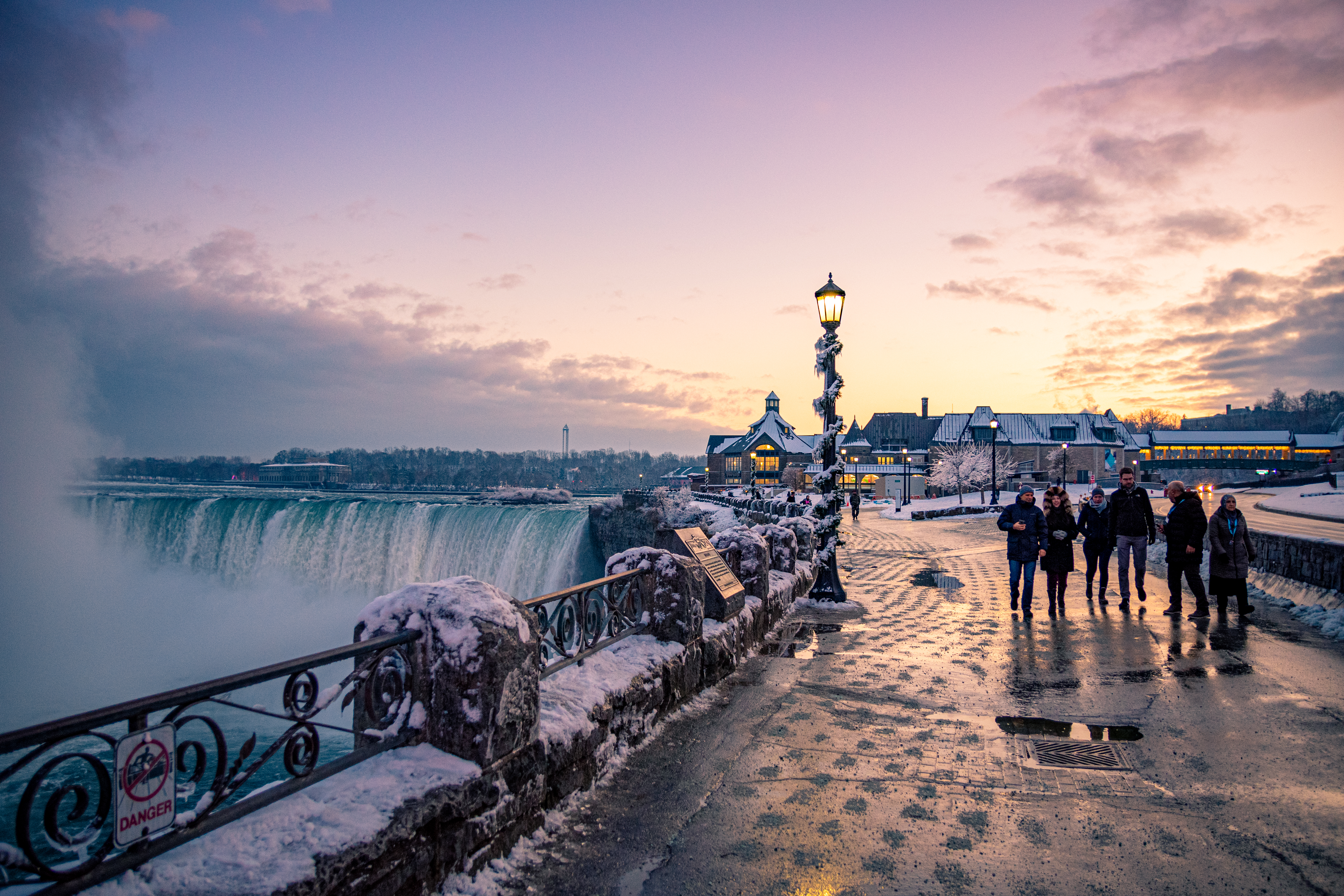 Group pass Horseshoe Falls of Niagara Falls in spacious park during winter season in Ontario, Canada