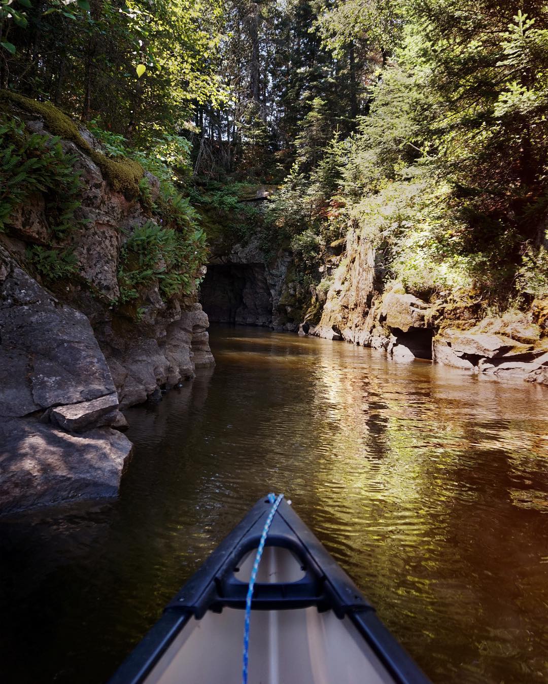 View from the front of a kayak as it travels through Caddy Lake rock tunnels