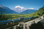 A VIA Rail train travels through the Canadian Rockies in the summer 