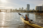 A person kayaking in False Creek in Vancouver on a sunny day