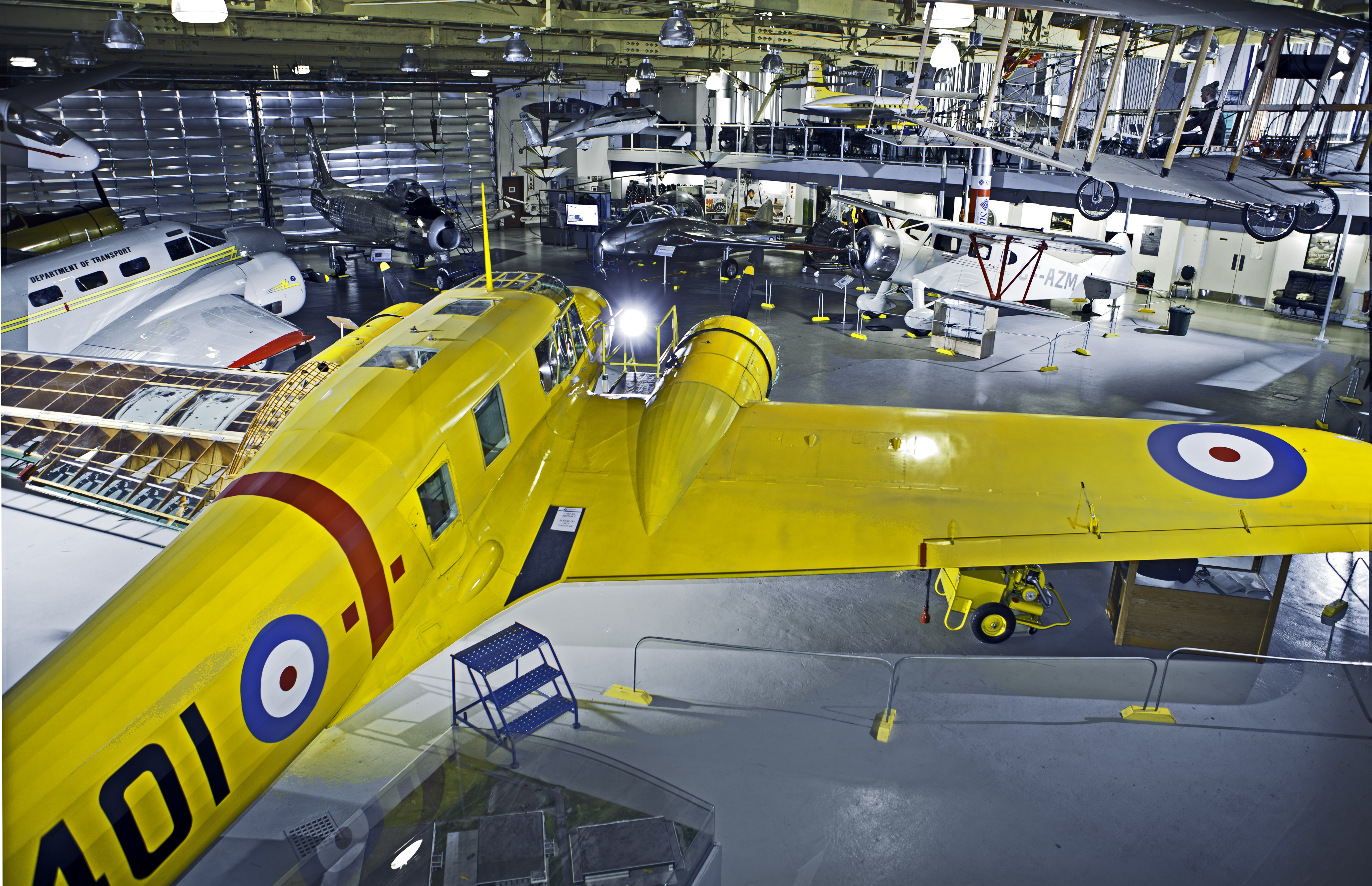 Yellow airplane and other vintage aircrafts inside the Hangar Flight Museum