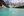 People paddling a yellow canoe surrounded by mountains at Moraine Lake in Banff National Park