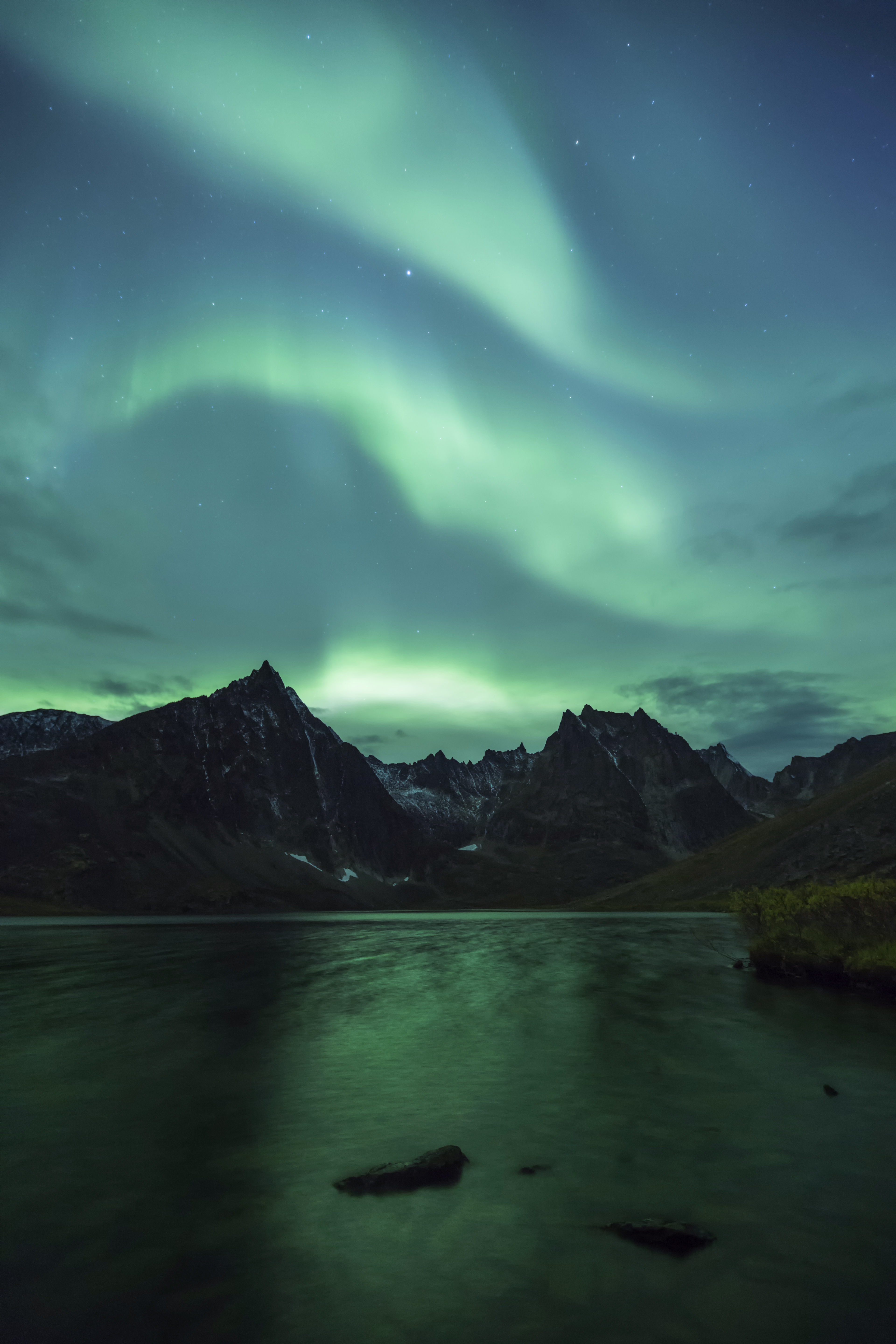 Three green streaks of the aurora borealis above Grizzly Lake, Tombstone Territorial Park, Yukon Territory