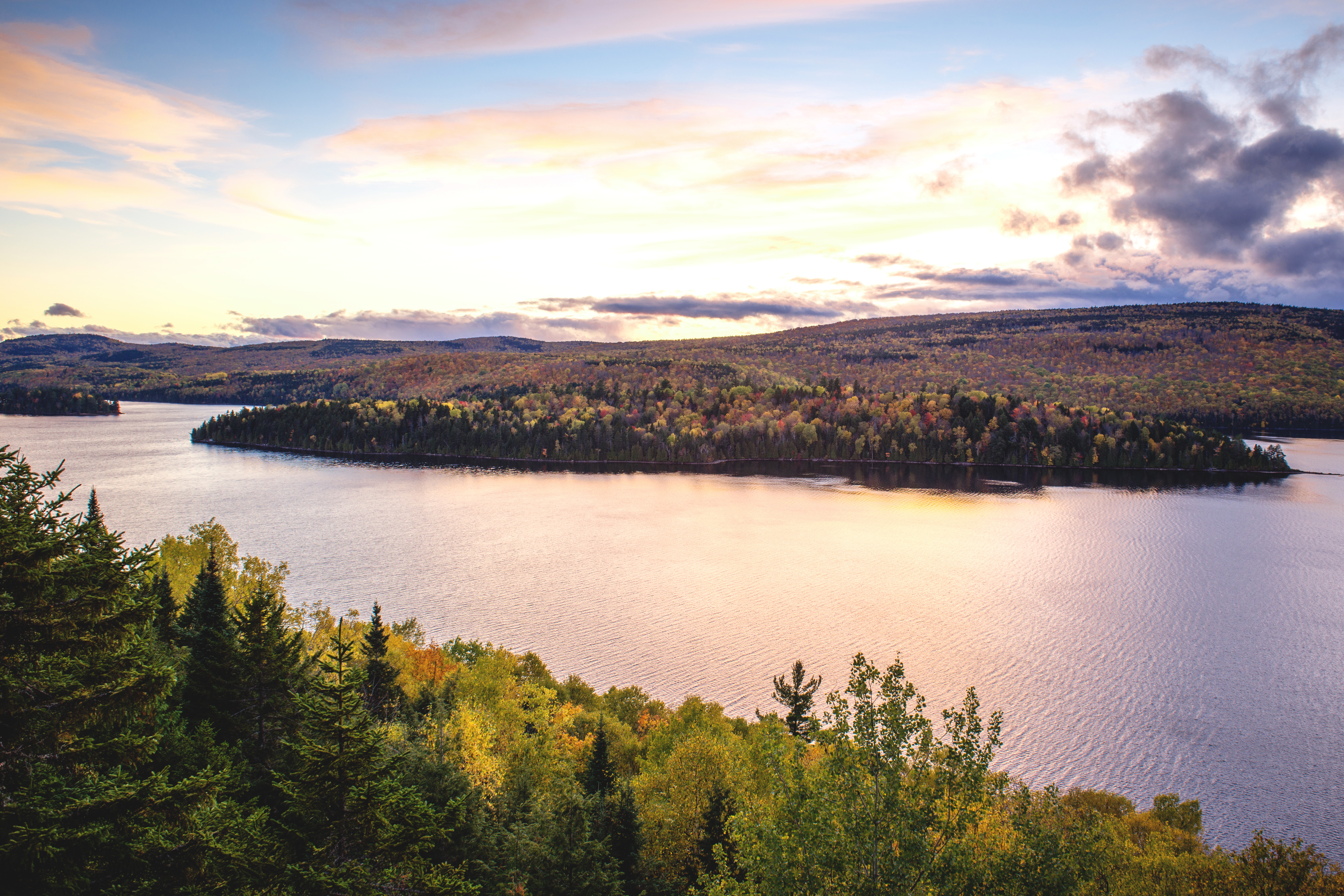 Sun shines on deserted island standing in Lac Sacacomie located in forest of Quebec's Mauricie Region
