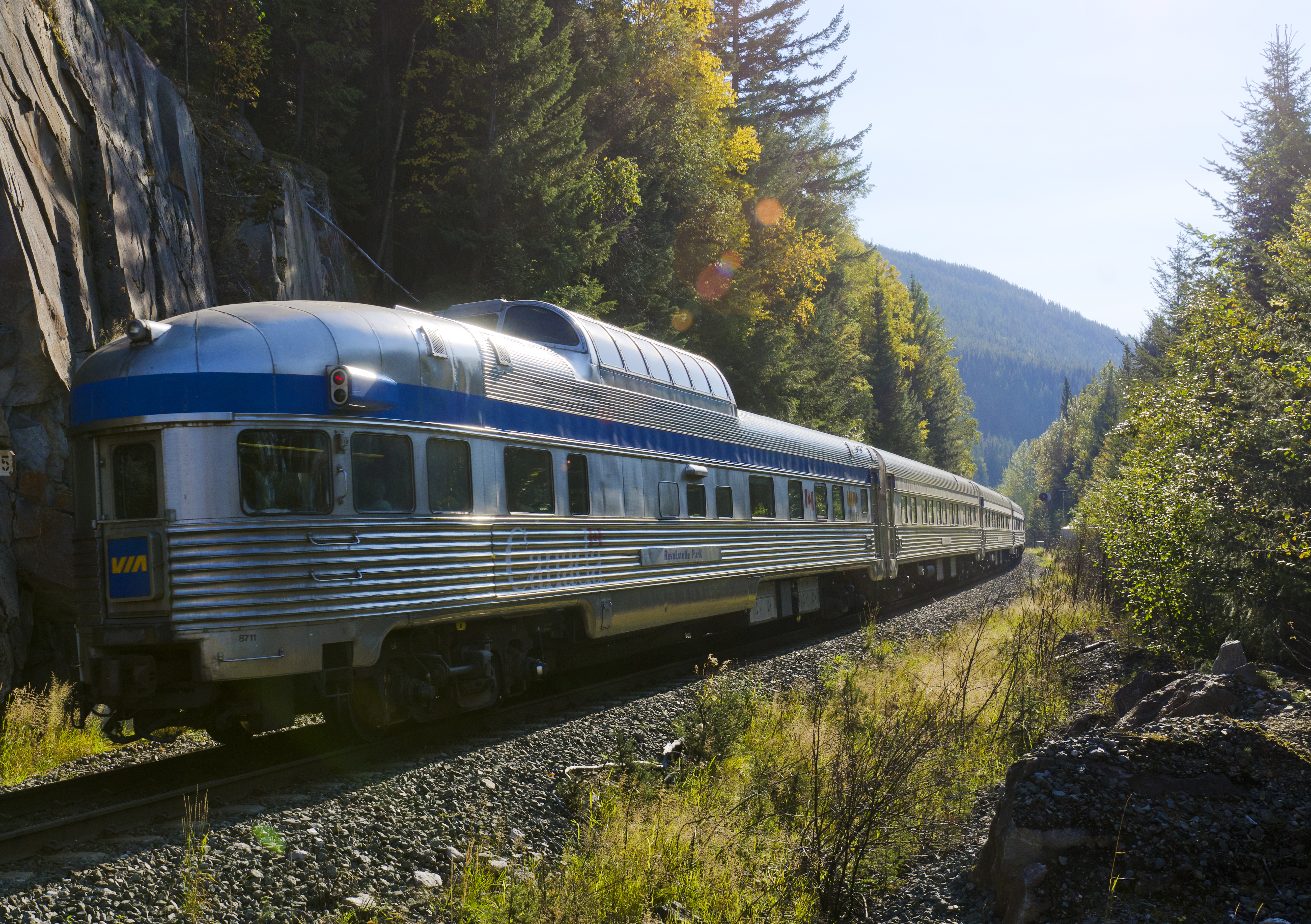 A VIA rail train travelling on the tracks