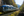 Close up of the front of VIA Rail Canadian train travelling through the forest