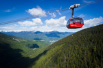 The Peak 2 Peak gondola in Whistler high above green trees and mountains