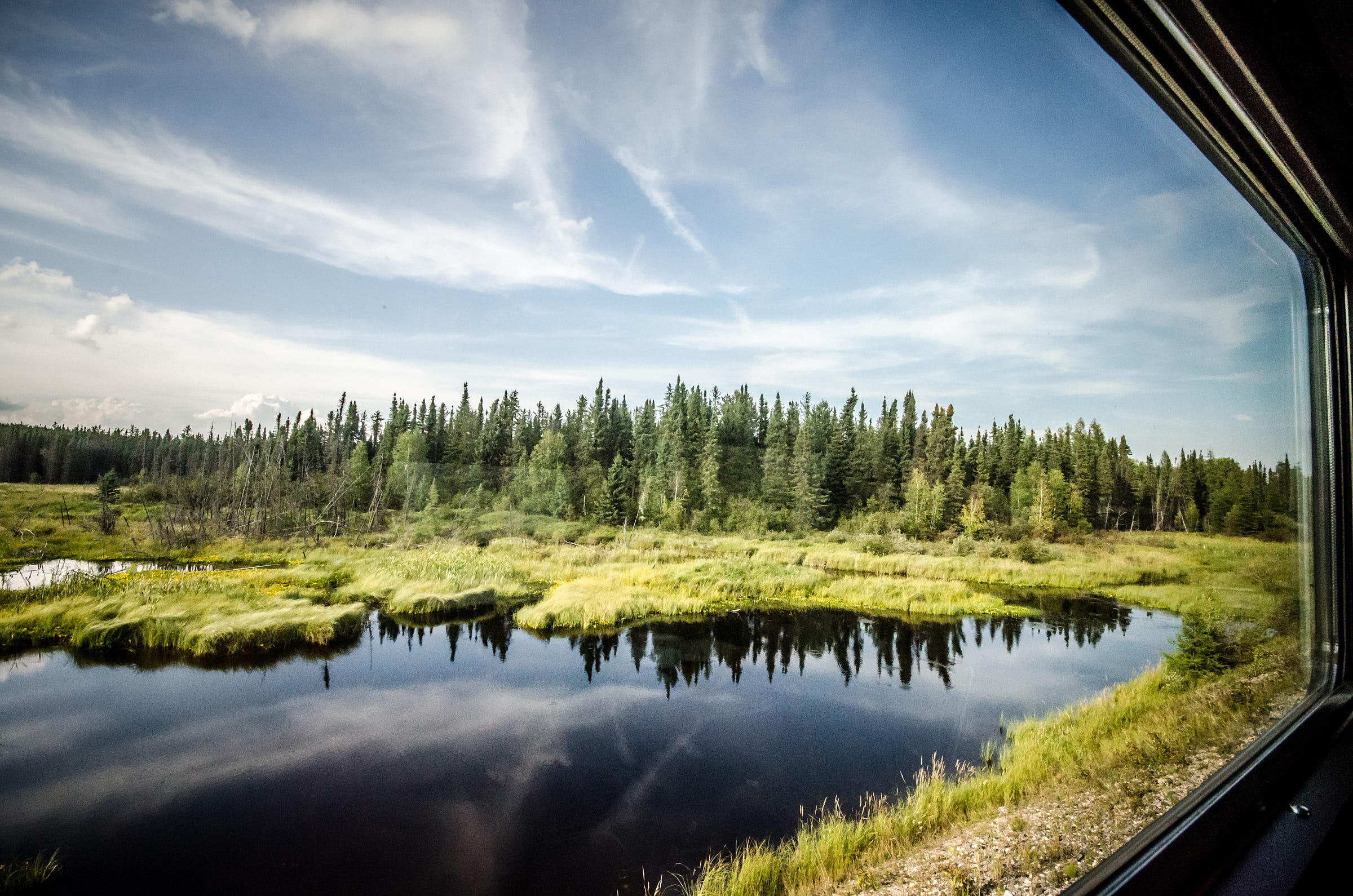 A view of a lake from the VIA train on the Toronto to Vancouver route