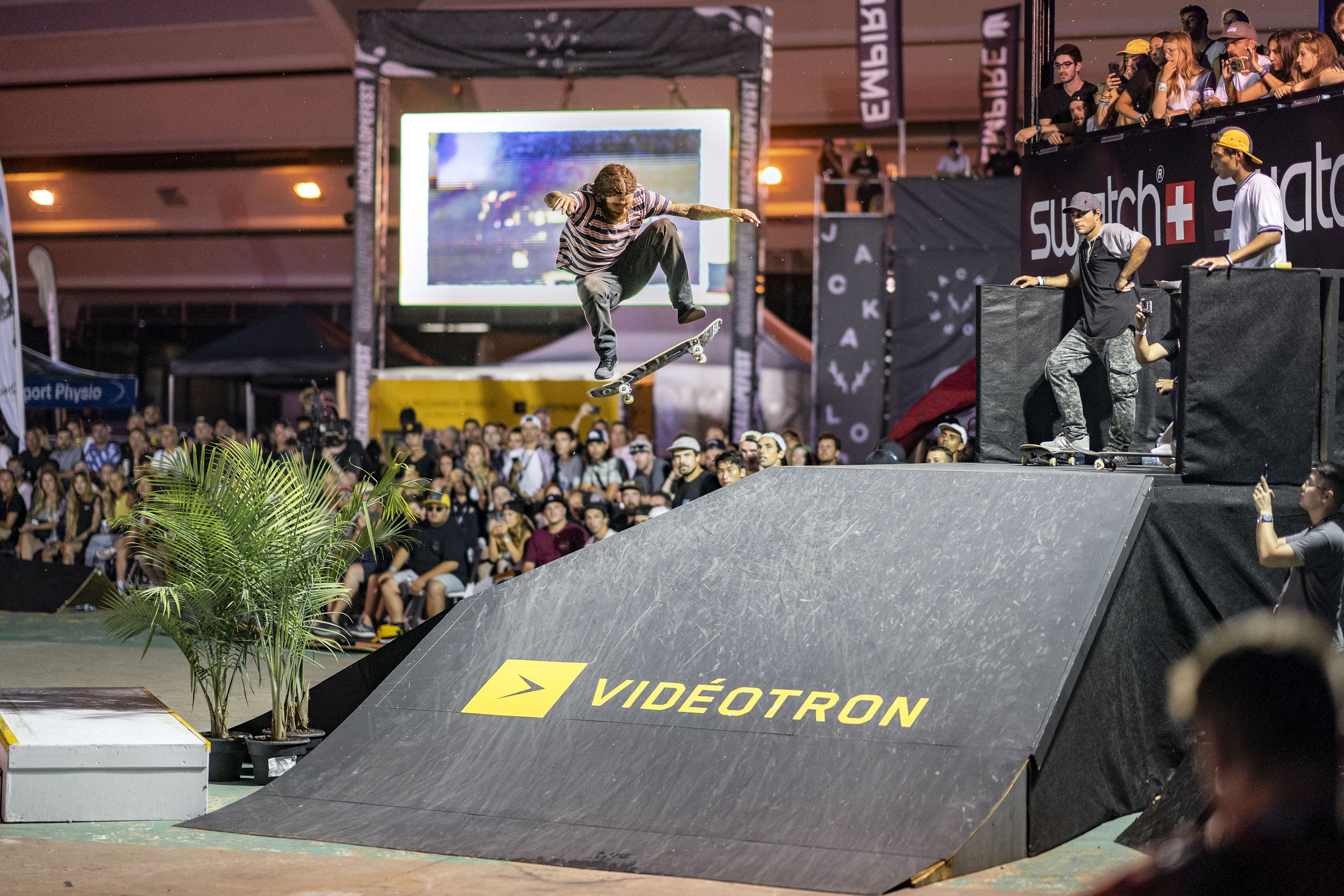 Person perfoming skateboard jumps as a crowd watches at the Jackalope Festival