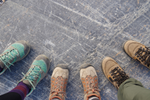 Three people wearing hiking shoes in Athabasca Glacier