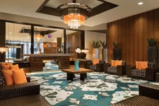 Modern hotel lobby with armchairs and chandelier