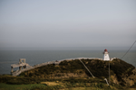 Lighthouse on towering cliff overlooks inlet in Waterside, New Brunswick