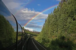 A view of a rainbow in the sky from the VIA rail train