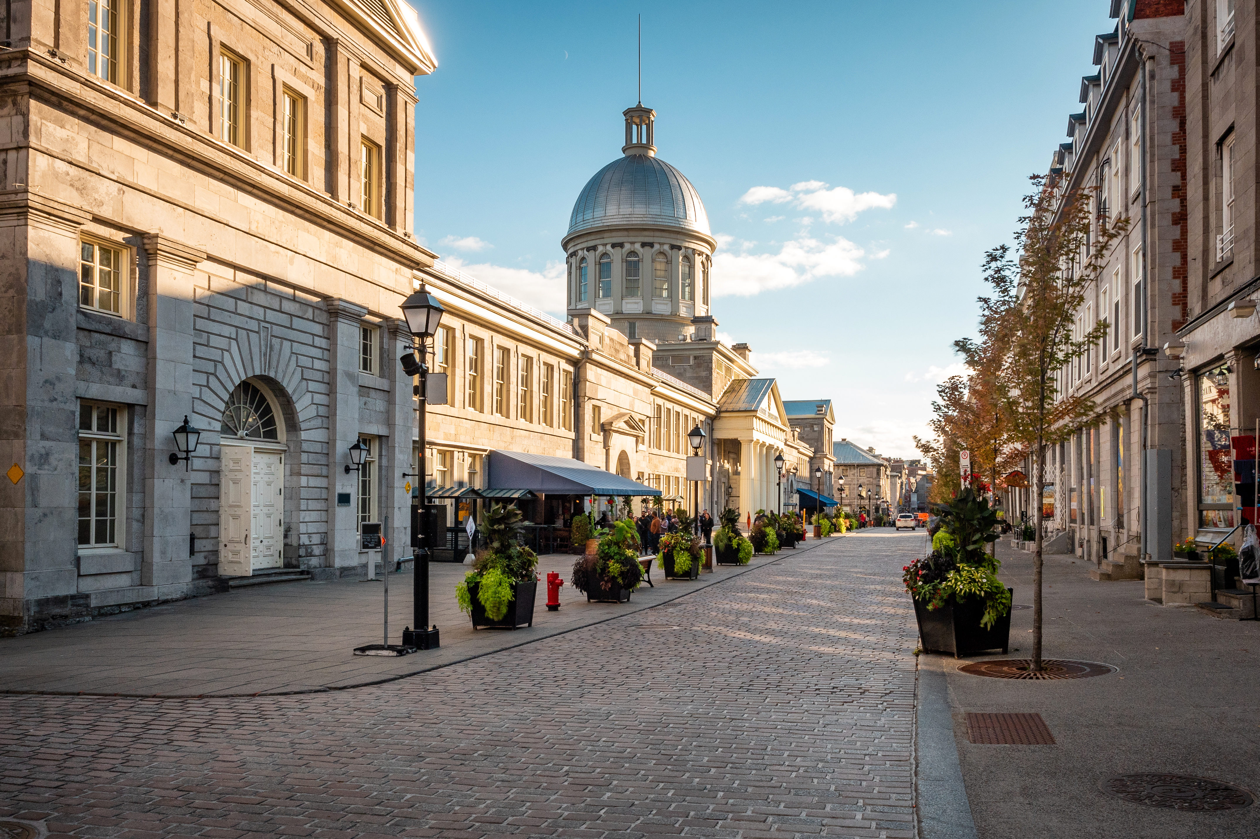 Streets of Old Montreal with brown rustic buildings and blue sky