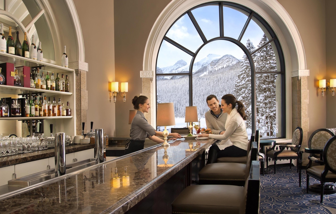 Two patrons of the Fairmont's Lakeview Lounge are pictured talking to a waitress.