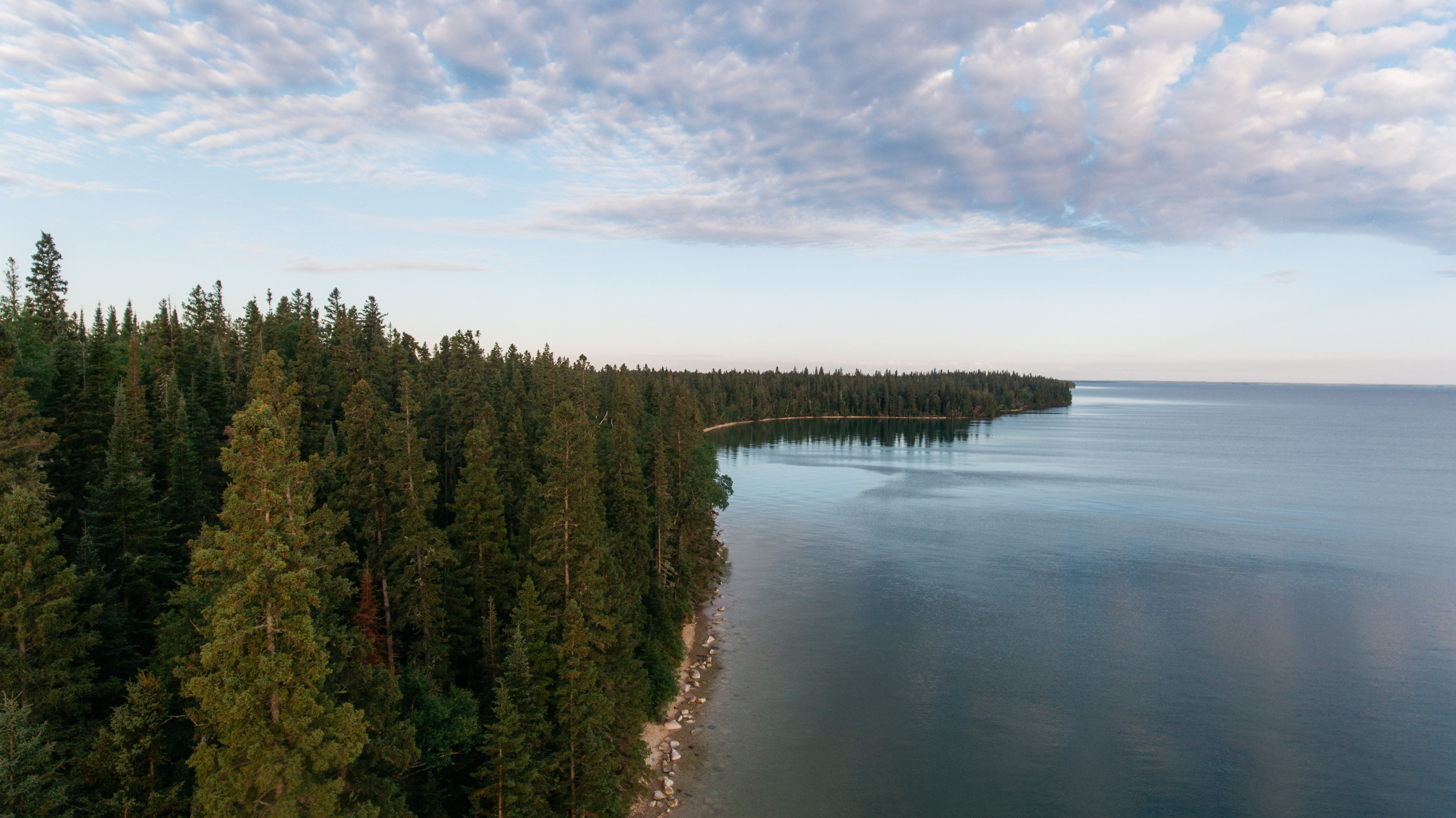 Aerial view of forest and beach next to Clearwater Lake in Manitoba