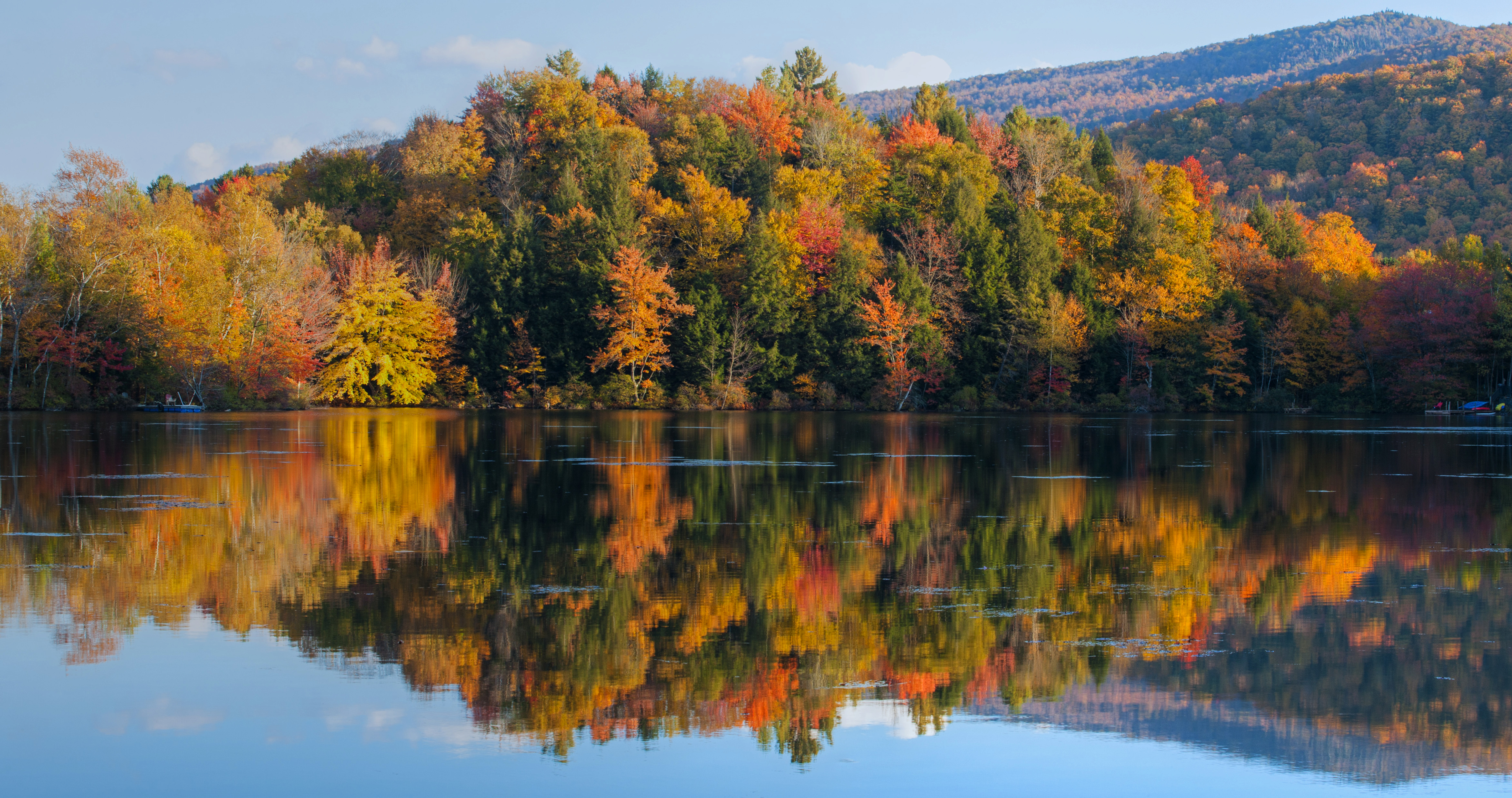 Autumnal trees with reflection in a lake in the Eastern Townships region of Quebec