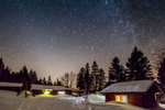 Cabins, in the Maritimes' Appalachian wilderness, in dark sky preserve on a crystal-clear starry night after snow