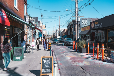 View of street and shops in Kensington Market neighbourhood during daytime