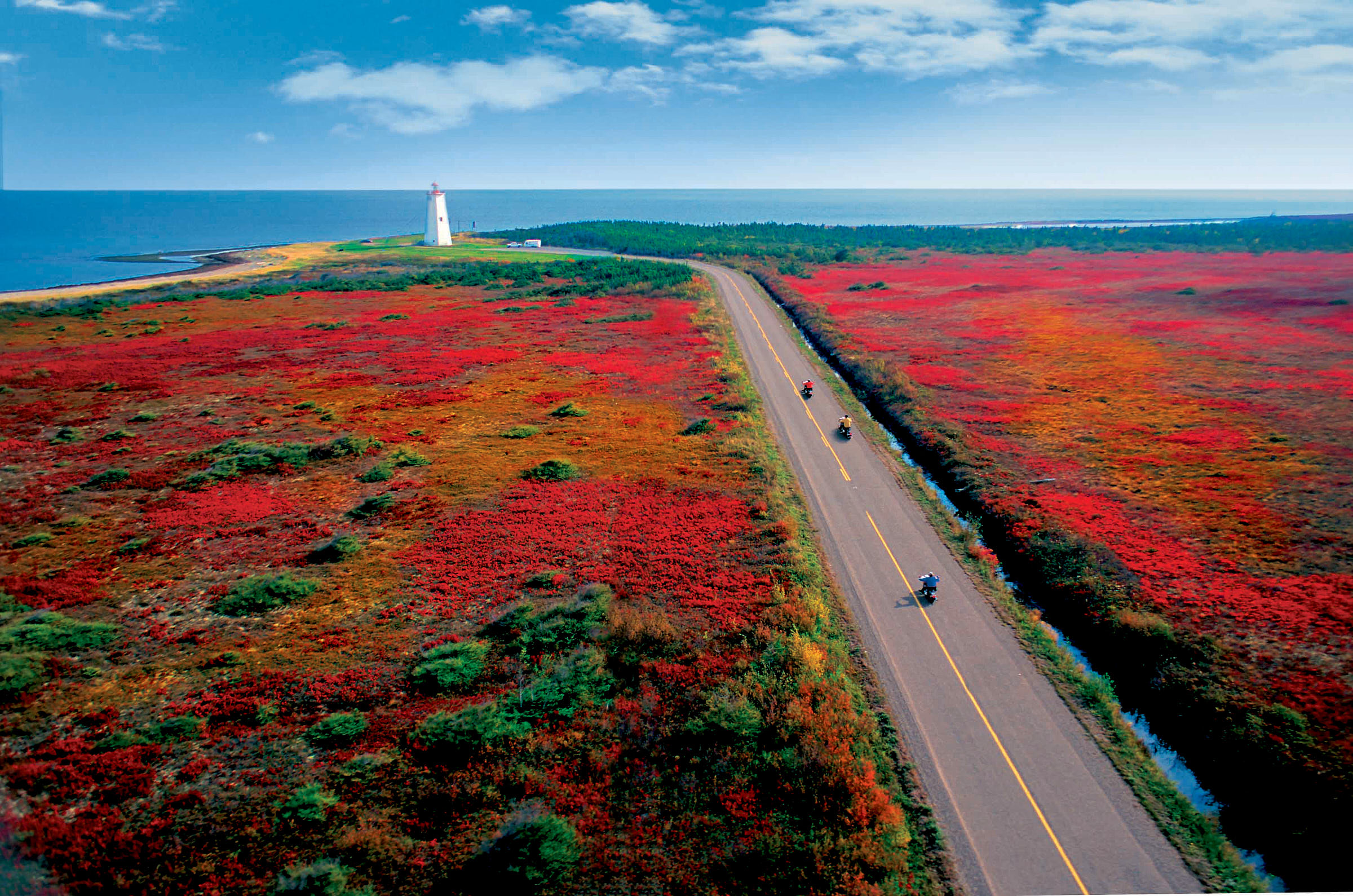 An aerial view of motorcycles travelling on the road on Miscou Island in New Brunswick