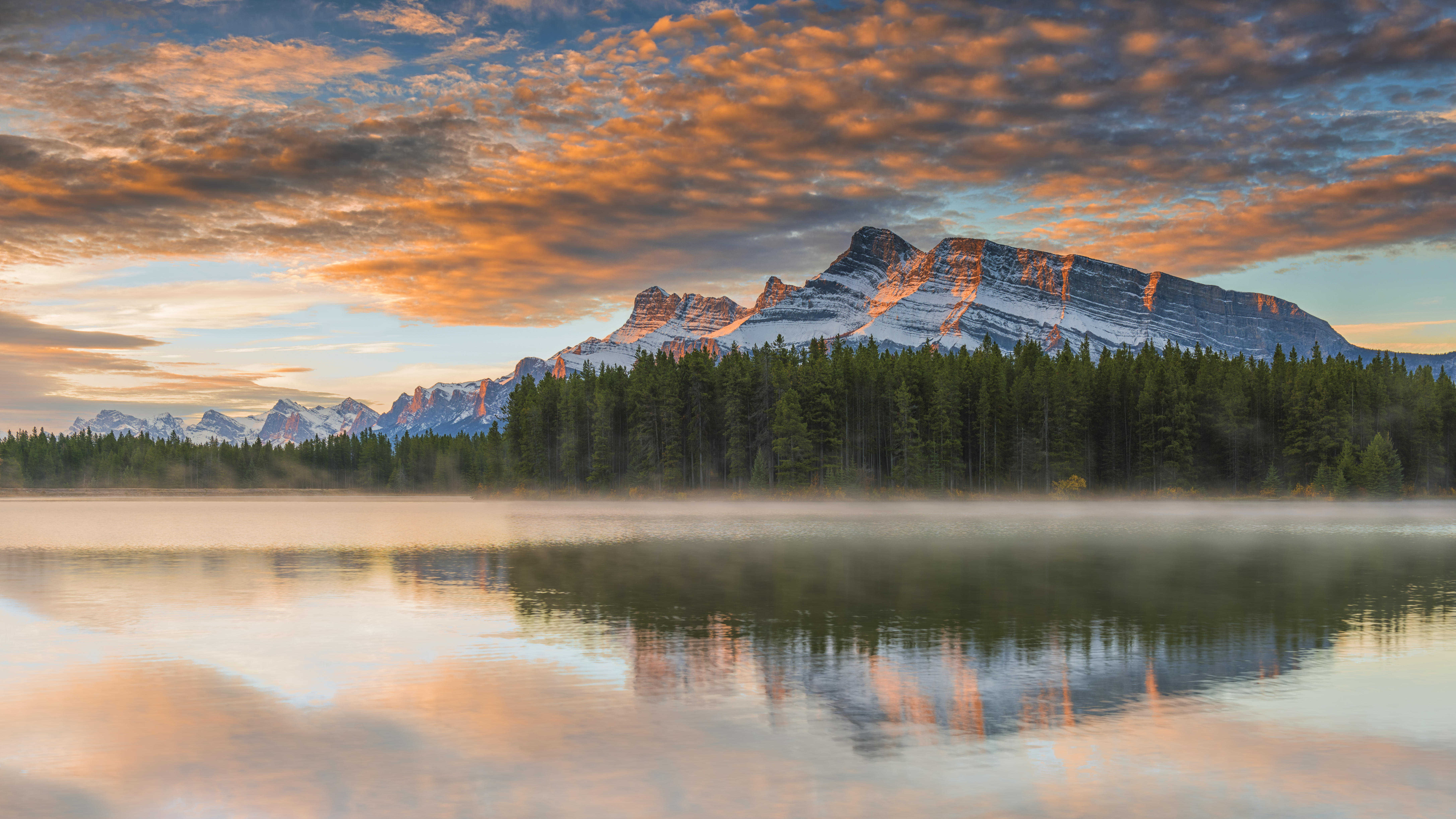 Mount Rundle by Two Jack Lake and its calm waters near Banff as sun sets