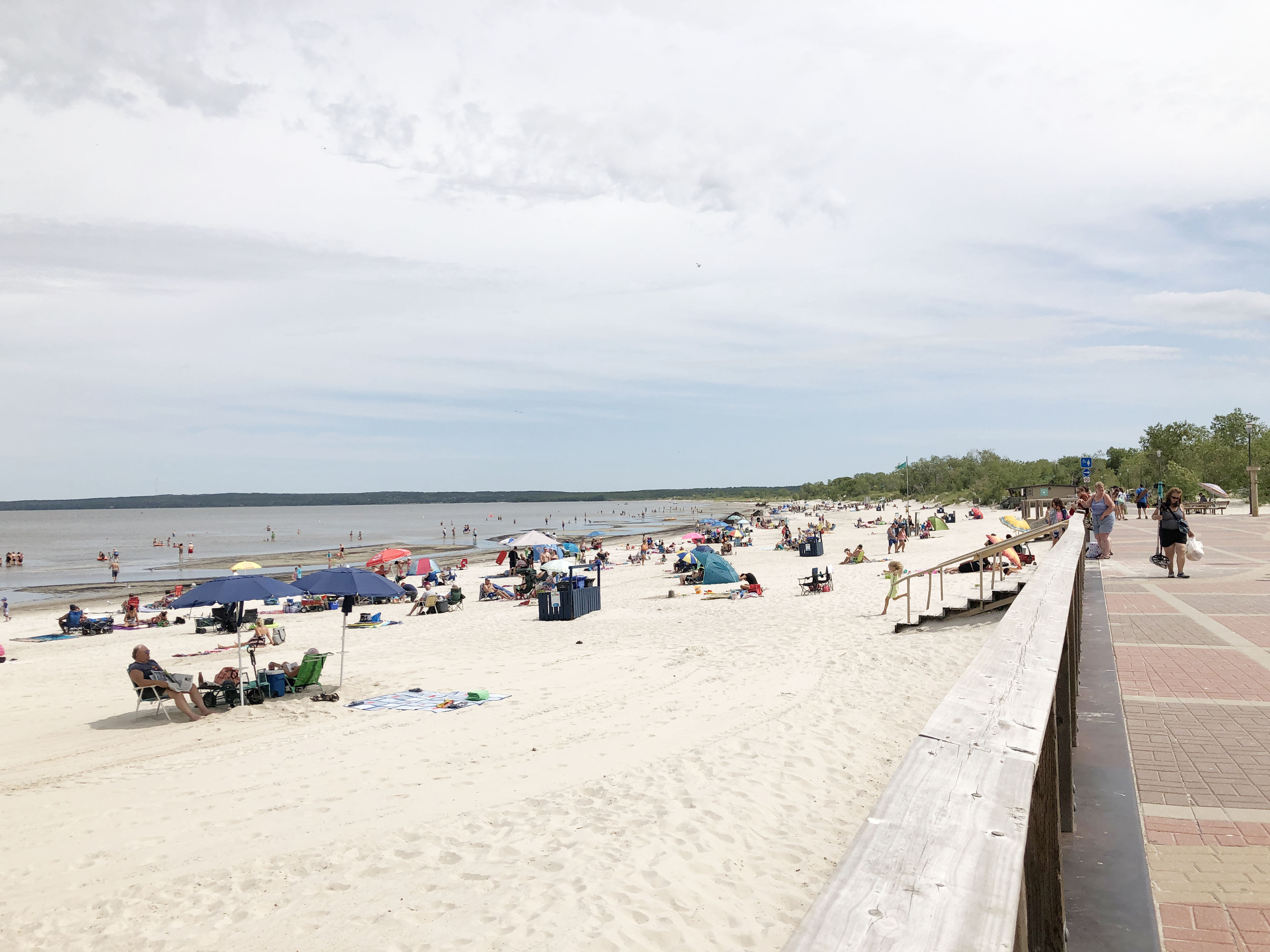 People relaxing on a white sandy beach in Manitoba