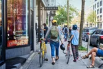 People walk with bikes through Montreal's Mile End neighbourhood