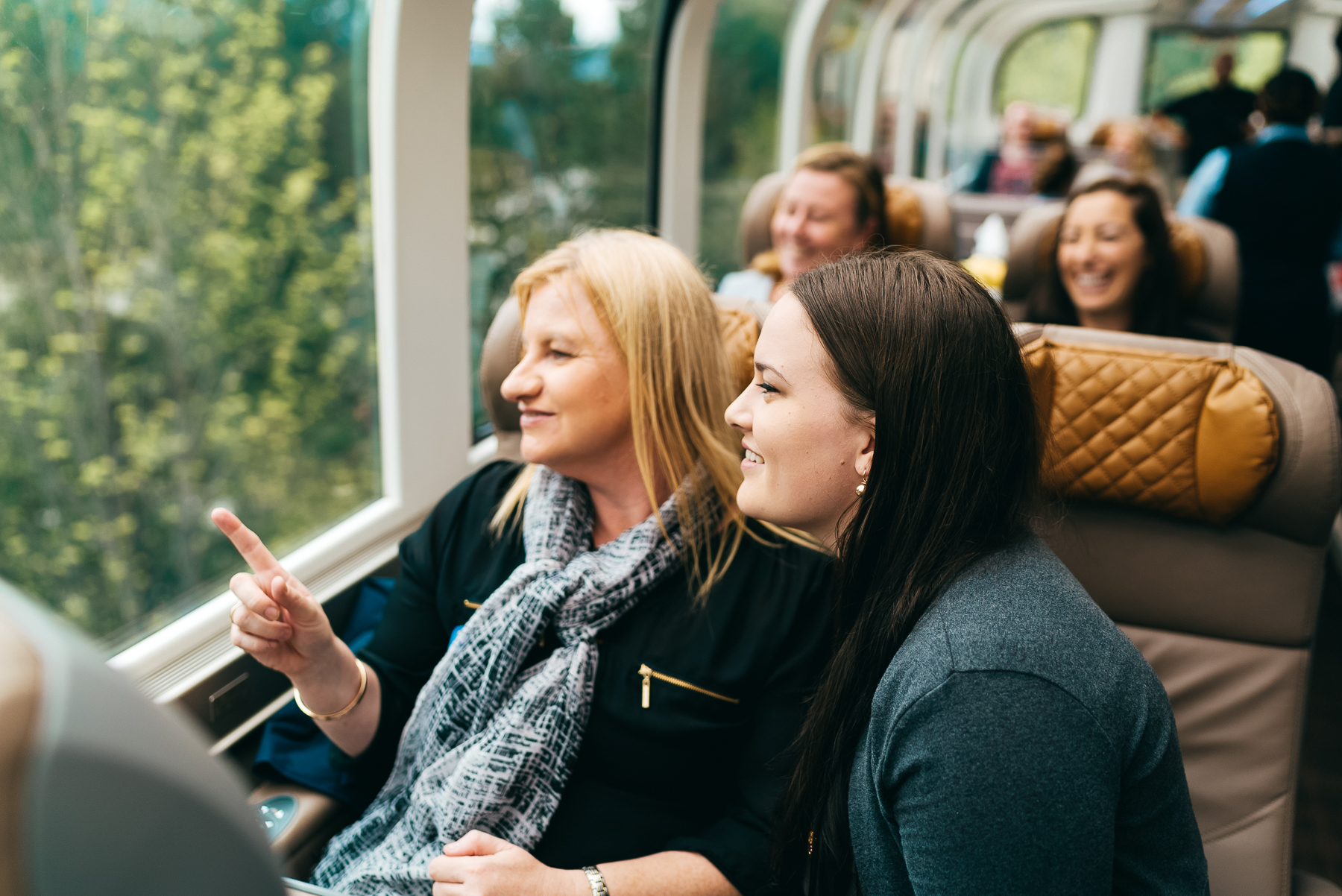 Rocky Mountaineer guests enjoying the scenery from their seats in the GoldLeaf service coach