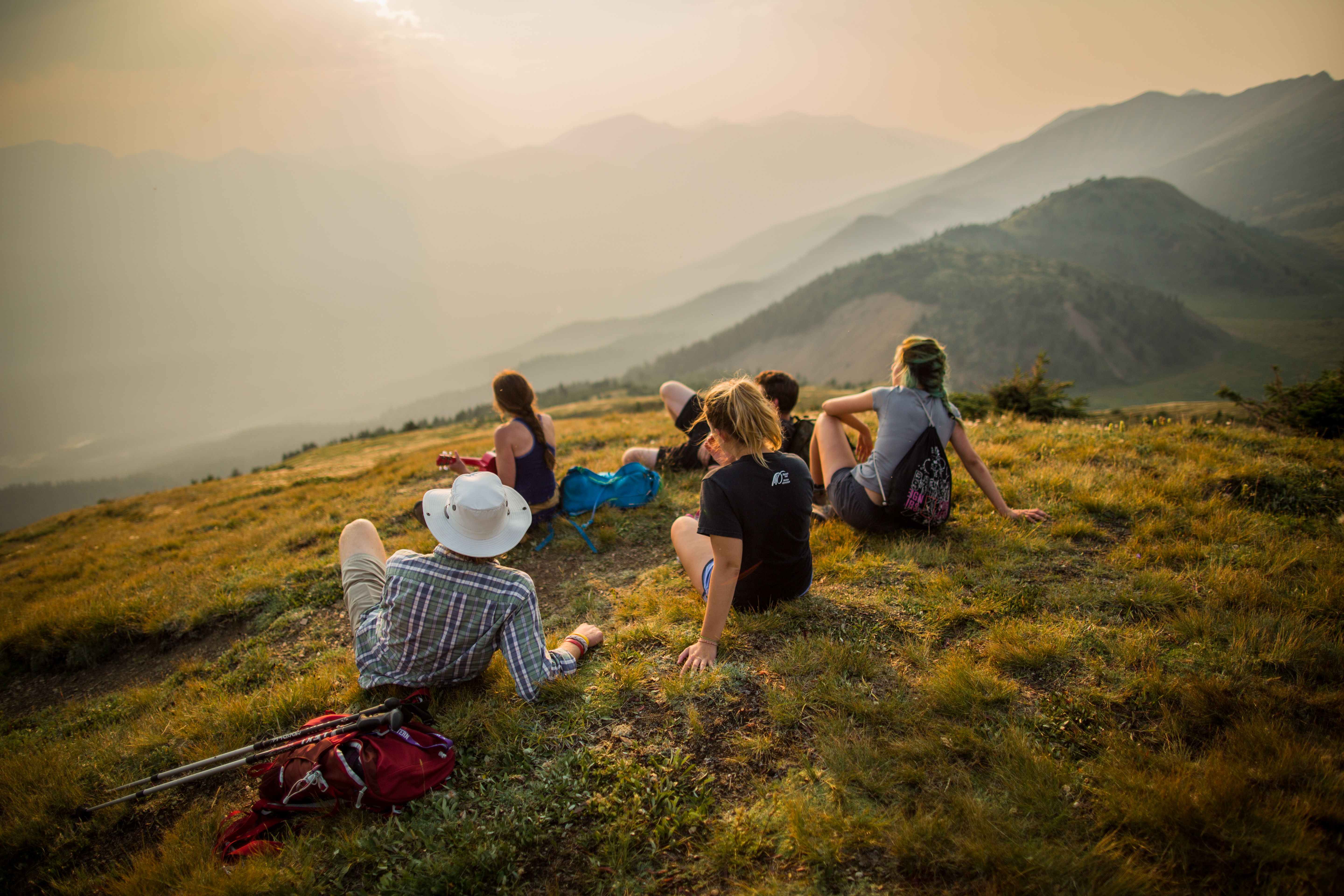 Group of friends sitting on a grassy hill