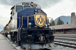 Close up of Rocky Mountaineer train sitting on the tracks at Banff station