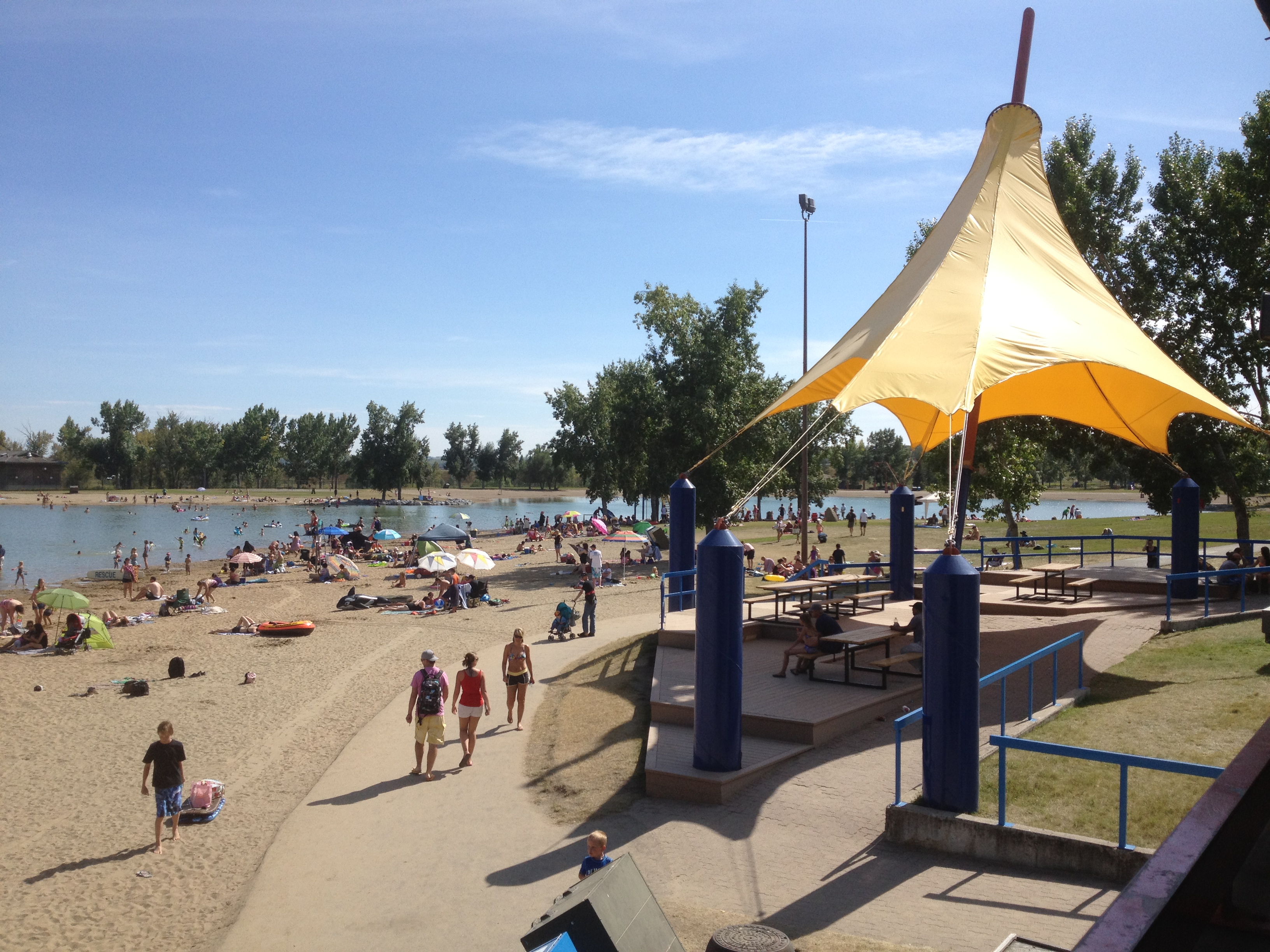 People on Sikome Lake beach on a hot summer day