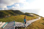 Two women walk down the steps of the Skyline trail toward the ocean lookout