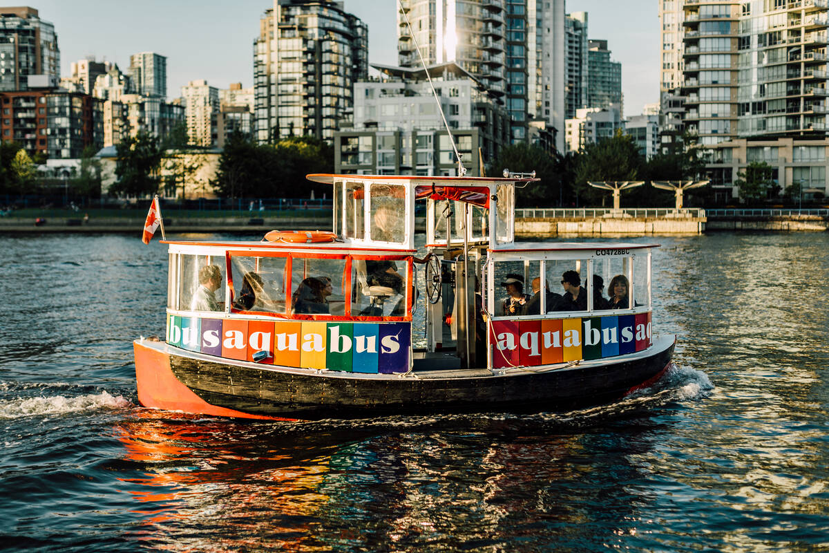 Close up of an Aquabus (small boat) cruising through False Creek 