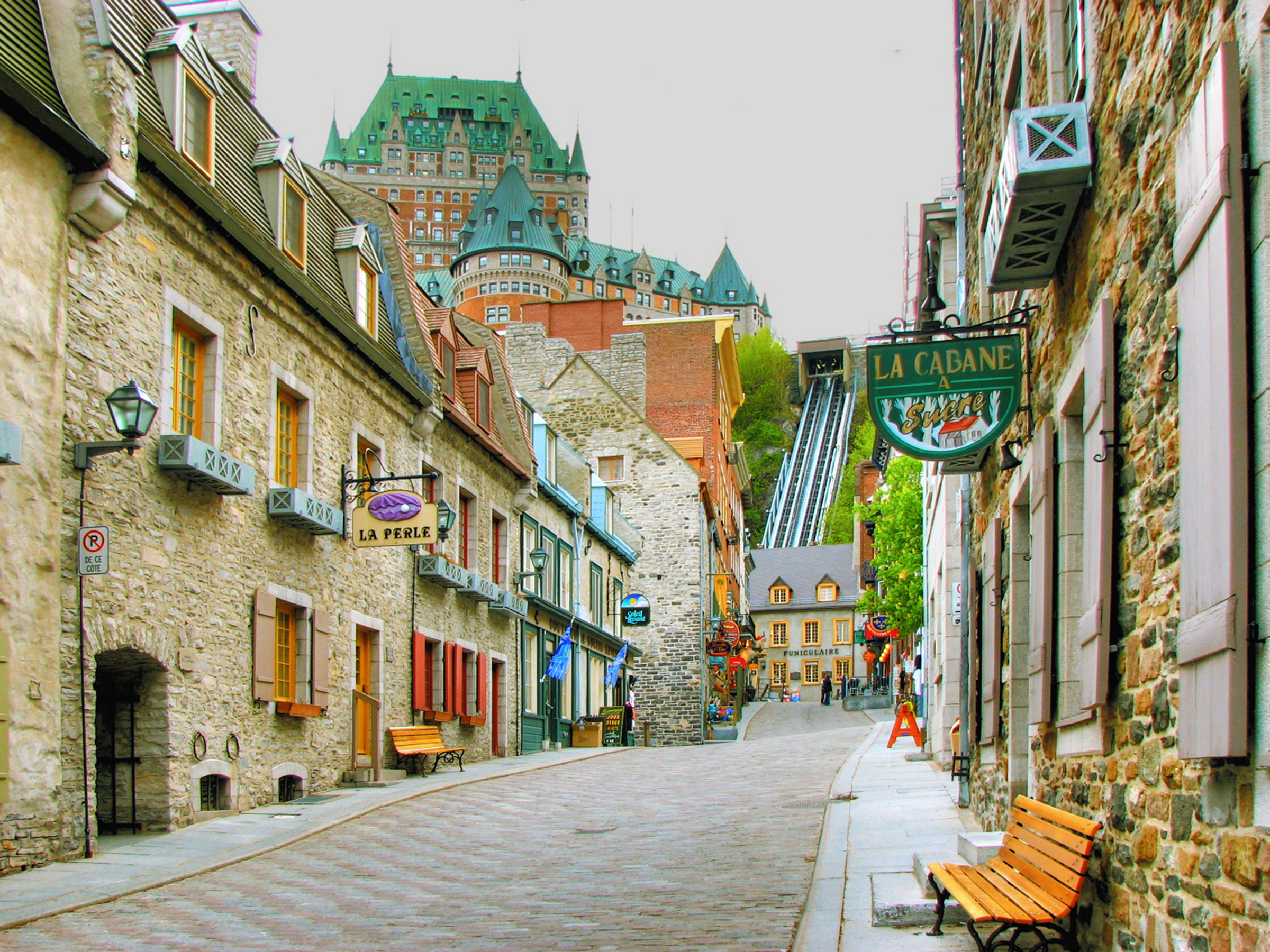 Old Quebec City street on quiet afternoon. Chateau Frontenac in background