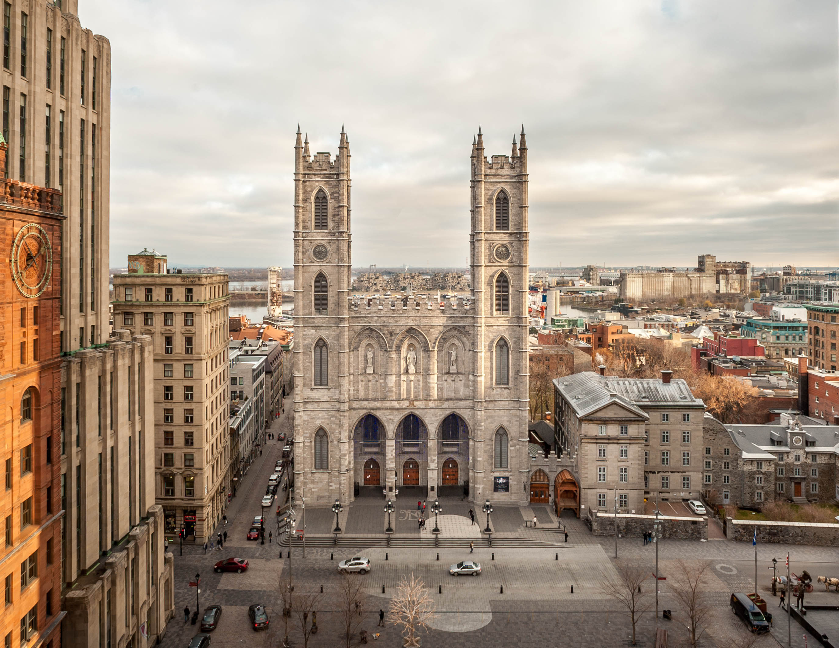 The Notre-Dame Basilica, an iconic landmark in Montreal, is surrounded by historic buildings 