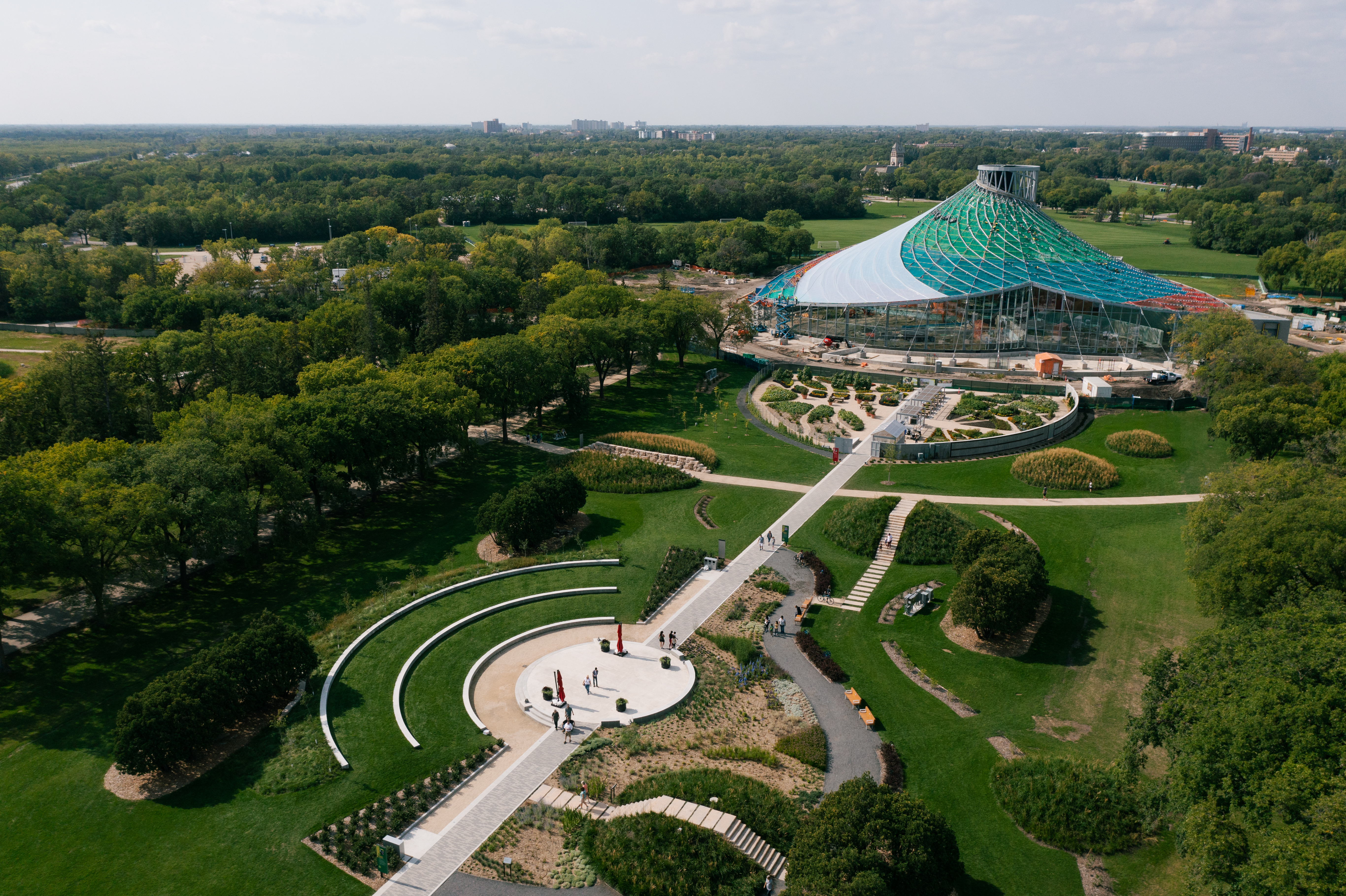 Aerial shot of a The Leaf, a modern building with curved roof, and surrounding gardens