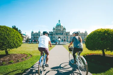 Two cyclists in front of BC Legislature