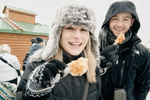 A couple enjoys sugar shack maple taffy candy at Quebec City’s Winter Carnaval